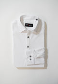 A neatly folded white button-up shirt with a collar and three visible buttons, placed on a white surface. The label inside the collar reads MARC NELSON.